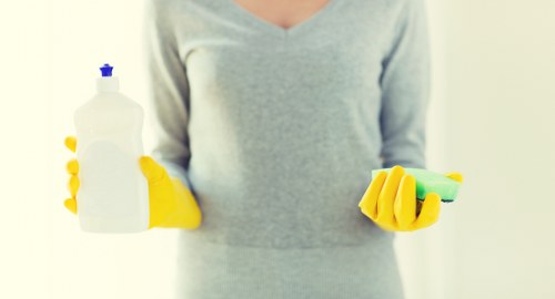 Insured carpet cleaning service team member preparing equipment